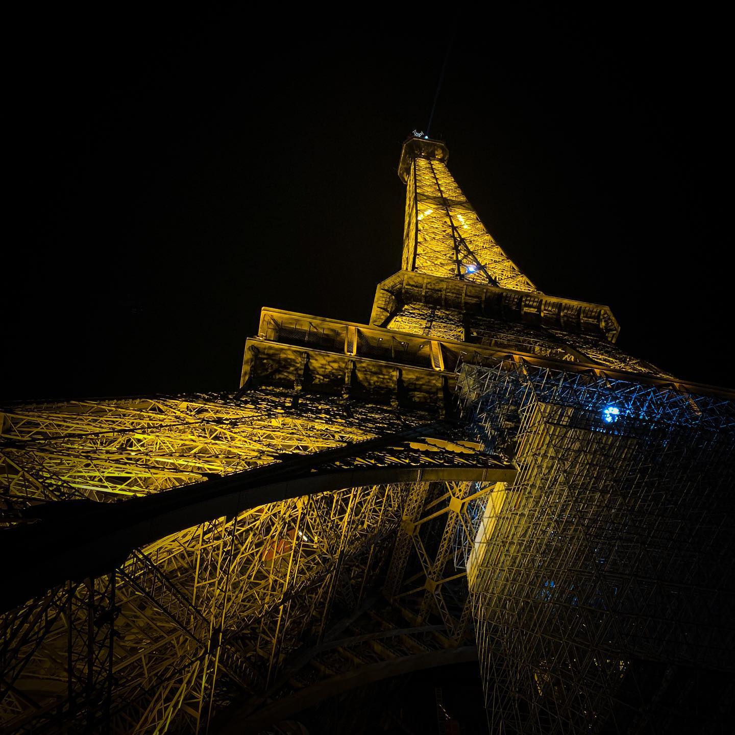 The illuminated Eiffel Tower beside the Seine during a Eurovision-related shoot