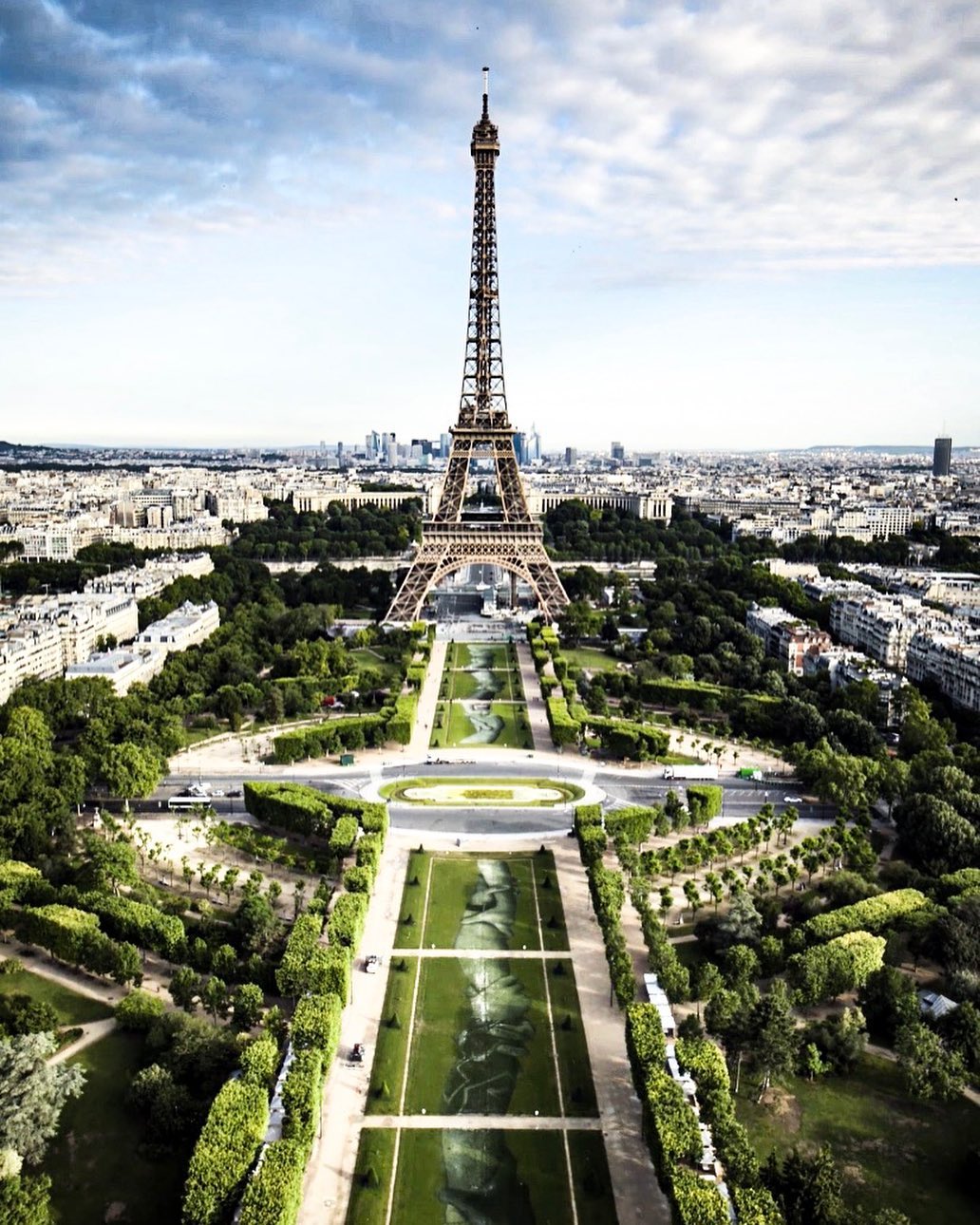 Aerial view of Saype’s Beyond Walls artwork on the Champ-de-Mars lawns, in front of the Eiffel Tower